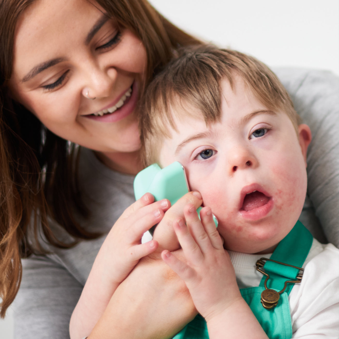Mom soothing her son's cheek with the Cosi Care Scratch Star